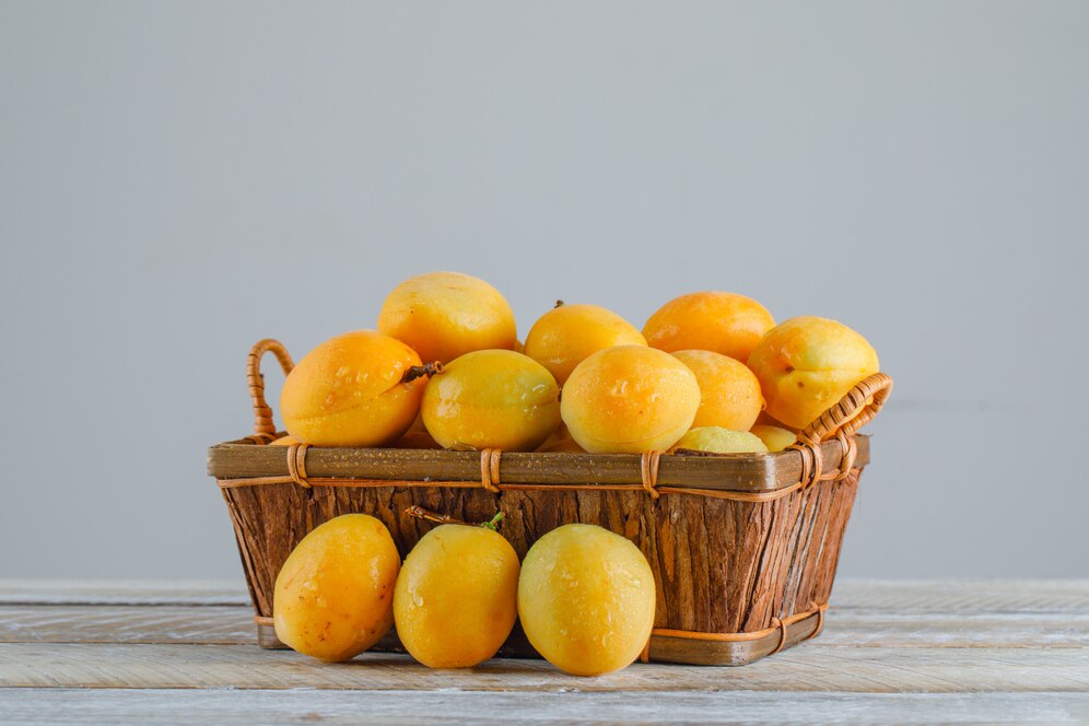 apricots-basket-wooden-table-side-view_176474-9109 (1)