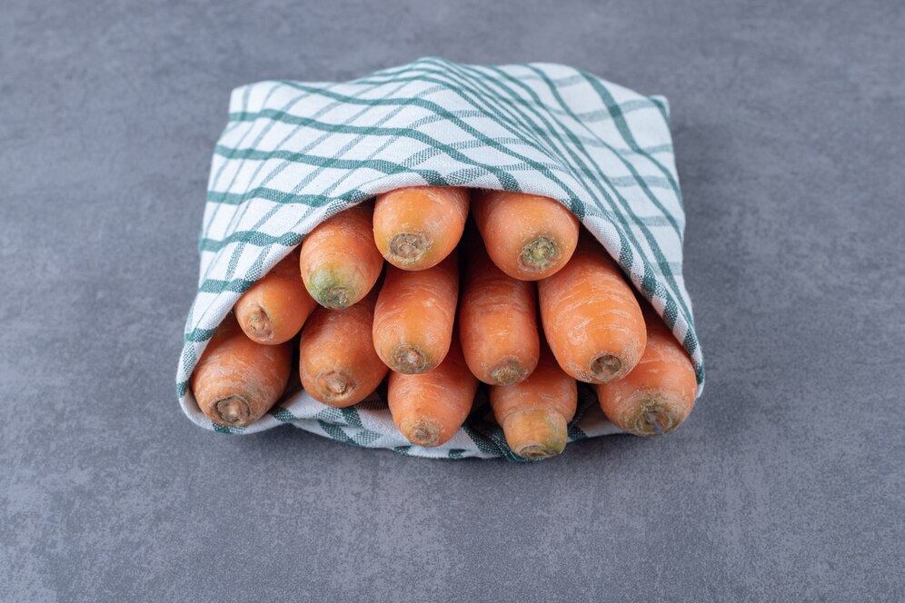 carrots-wrapped-towel-marble-surface_114579-63896