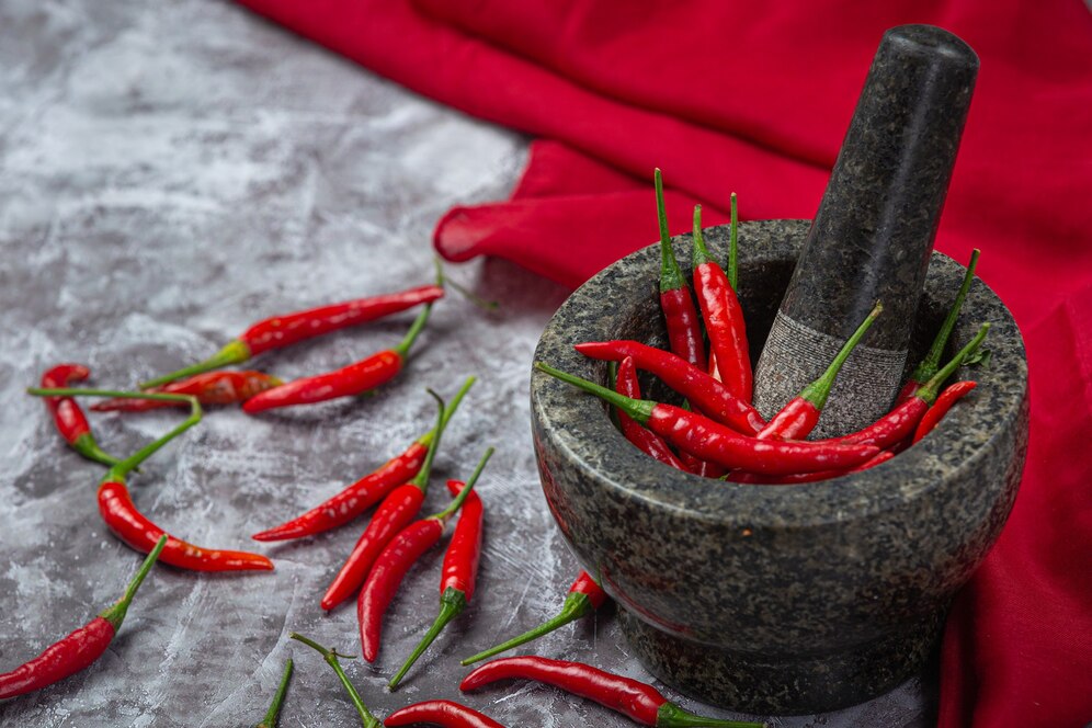 red-chillies-are-stone-mortar-black-surface_1150-25565