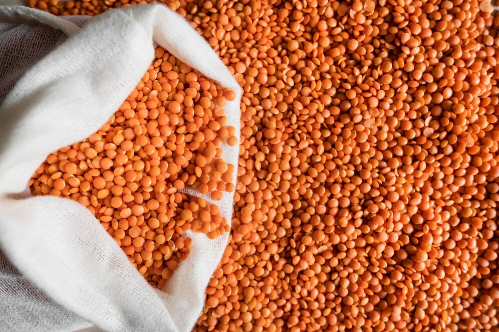 top-view-orange-beans-bag-with-copy-space_23-2148685801